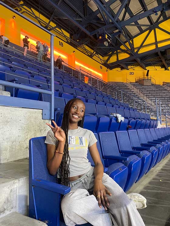 Mariane Iman Ndiaye taking a selfie at a basektball game