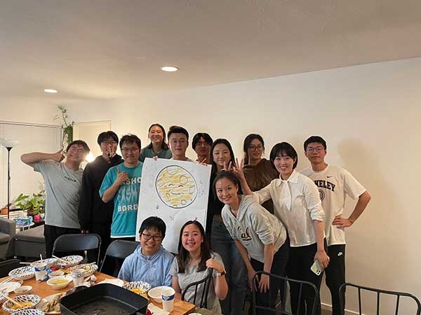 Xiangjian Zhang and friends having a game night at an apartment