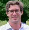 Headshot of Alexander Meek standing in front of trees